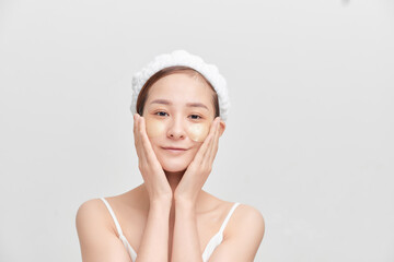 Beauty portrait of Asian attractive young woman isolated over white background, wearing towel on her head