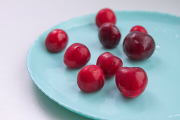 ripe cherries on a blue plate