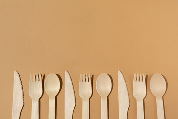 Contrast lighting. Flat lay. Eco friendly wooden cutlery. Fork and knife, spoon. Plastic Free Concept.