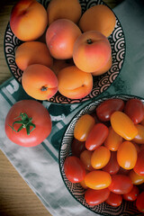tomatoes and apricots on the table