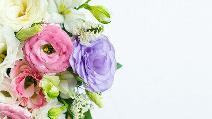 pink, white, purple pastel shades of eustomas in a bouquet, copy space for text to the right