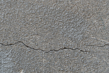 Obraz premium relief concrete wall with deep cracks and scratches