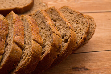 Assortment of baked bread on wooden table background