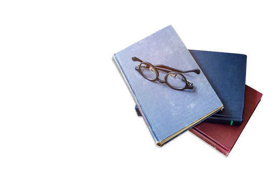old book with eye glasses isolated on white