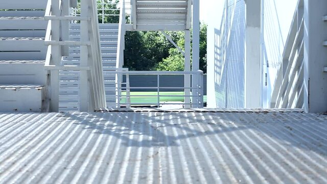 Man in suit pants and white shirt with high security bulletproof protect case climbs modern stairs outside the building