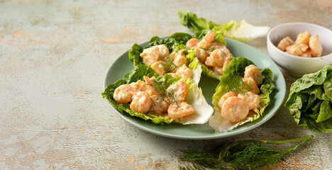 Side view of a plate with salad leaves and prawns with copy space