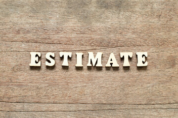 Fototapeta premium Alphabet letter block in word estimate on wood background