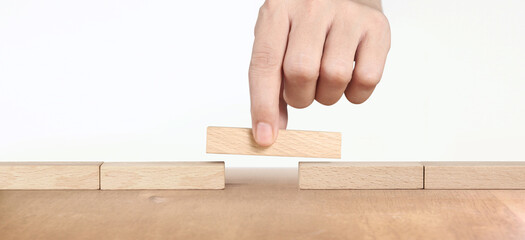 Hand placing wooden block, Planning of project management in business