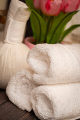 Fototapeta na wymiar Spa towels, cosmetics, and herbal compress
