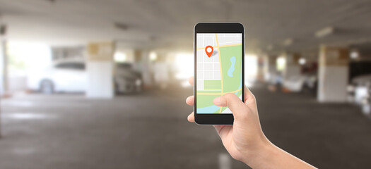Hand holding smartphone device and touching screen, which is icon of the location, Concept of online navigation GPS