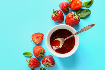 Bowl of tasty strawberry jam on color background