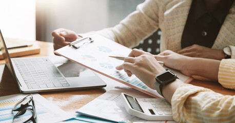 Asian business adviser meeting to analyze and discuss the situation on the financial report in the...