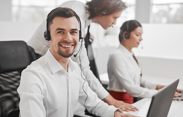 Friendly call center operator near colleagues