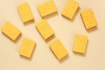 Sponges of yellow colors on a beige background.