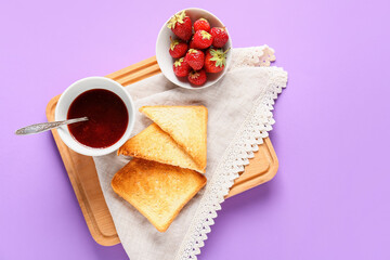Bowl of tasty strawberry jam and bread on color background