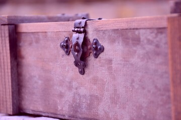 Old moldy wooden box lock used to store a bottle of wine.