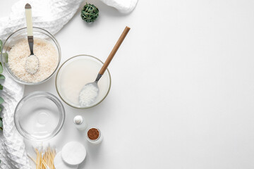Healthy rice water with cosmetic supplies on white background