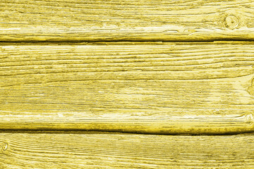 Yellow color wood surface. Broken wooden desk structure. Vintage board pattern design. Old peeling paint texture. Grunge cracked wooden wall background.