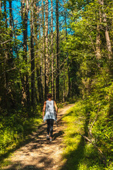 Fototapeta premium Young girl visiting the Listorreta Natural Park in the town of Errenteria in the Peñas de Aya or Aiako Harria Park in summer. Gipuzkoa, Basque Country