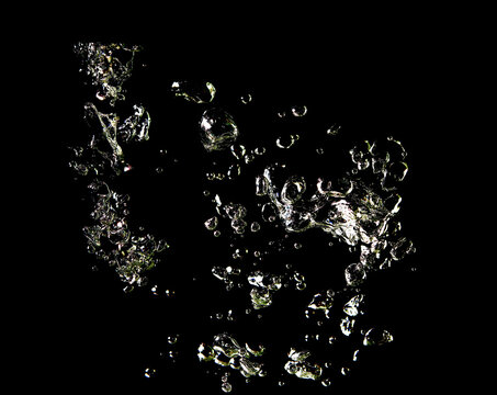 Close-up of white bubbles air under water isolated on a black background.