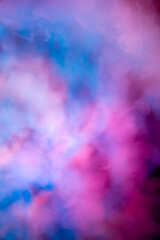 Abstract colorful, multicolored smoke spreading, bright background for advertising or design, wallpaper for gadget. Neon lighted smoke texture, blowing clouds. Modern designed.