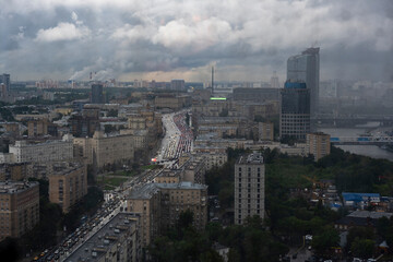 a view of a big city through the window where you can see that it is raining outside