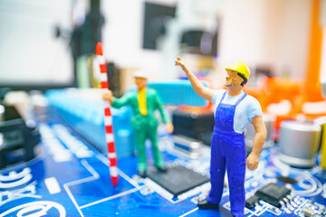 Miniature repair man on mainboard, Miniature figure of worker team try to repair cpu on mainboard.