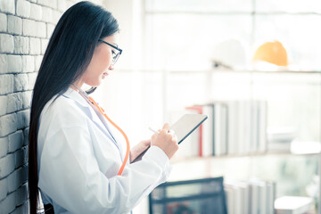 Smiling young female doctor holding  patient papers medical prescription for writing new medicine...