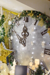 Christmas time concept. Big decorative clock with artificial and wooden fir trees and shiny golden stars. Minutes to midnight. Happy New Year eve.