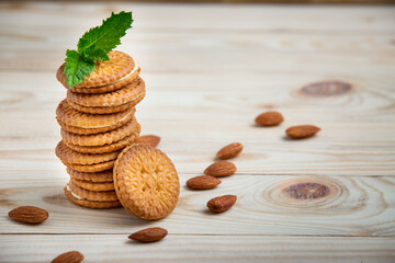 Chocolate sandwich cookies, baked biscuits stuffed with milk cream and almond on wooden table