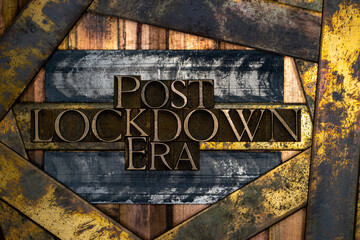 Post Lockdown Era text formed with real authentic typeset letters on vintage textured silver grunge copper and gold background