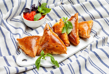 Delicious samosa on a tablecloth background