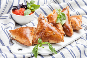 Delicious samosa on a tablecloth background