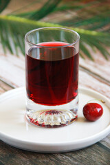 red cherry drink in glass and cherry fruit