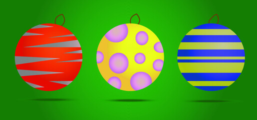 three Christmas toys of different colors with abstract patterns on a green background