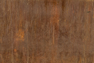 Old rusty metal surface with black paint flaking and cracking texture
