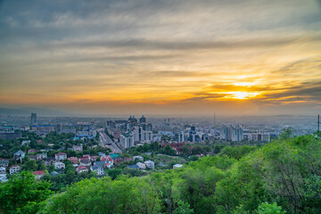 Fototapeta na wymiar Almaty city at sunset from a height. Impressive view.