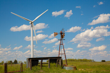 New and old windmills. A new power generating windmill and an old windmill powering a water pump...