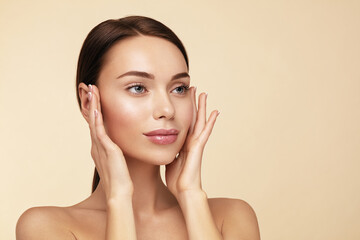 Skin care and beauty treatmets. . Model with perfect skin touching face.