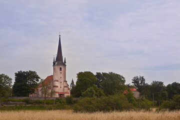 Fototapeta na wymiar Harju-Madise Church in Estonia, located on a high limestone cliff. Building stone construction from the 15th century. church tower was used as lighthouse