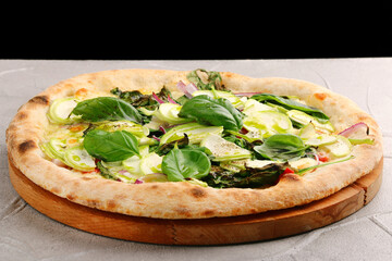 pizza with zucchini closeup on light concrete or stone table. Vegetarian pizza with zucchini, mozzarella, onion and basil