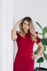 A model girl in a business suit. Clothing demonstration in a showroom.