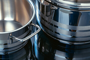 Set of aluminum pans on black surface close up