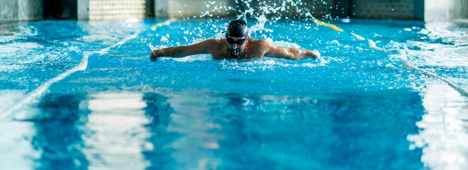 professional swimmer doing exercise in indoor swimming pool