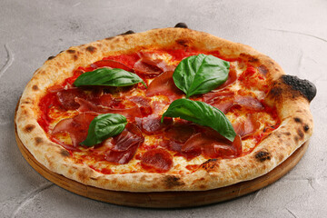 pizza pepperoni on light cement or stone background. pizza with pepperoni, basil and meat close up