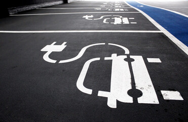 Electric car charging station in indoor parking garage. Empty parking spots with the electric...
