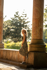 Young woman standing in park on sunny day