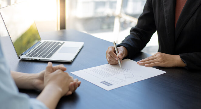 Asian female leader is interviewing new job applicants in the meeting room.