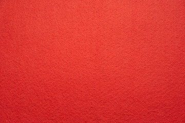 antique colored paper background texture with dark in old distressed vintage design. The color of the paper red Christmas texture