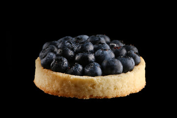blueberry tart close up isolated on black background